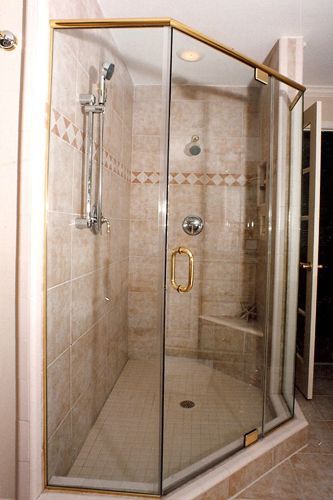 Our very first frameless shower door in 1994! Can you tell by the brass hardware? It’s coming back in style! This enclosure was considered frameless for its day.