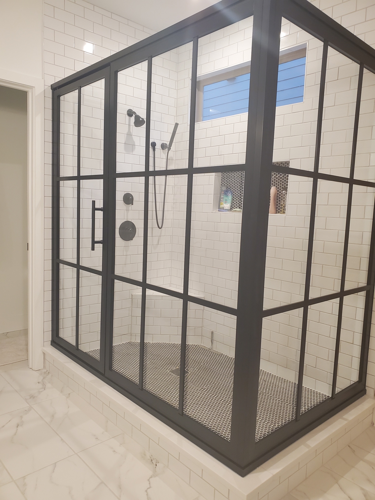 This Coastal gridscape shower is the real deal! This is a framed enclosure which adds to the dimensional appearance of the grids. The grids are only applied to the outside of the shower enclosure to ensure cleaning is a breeze!