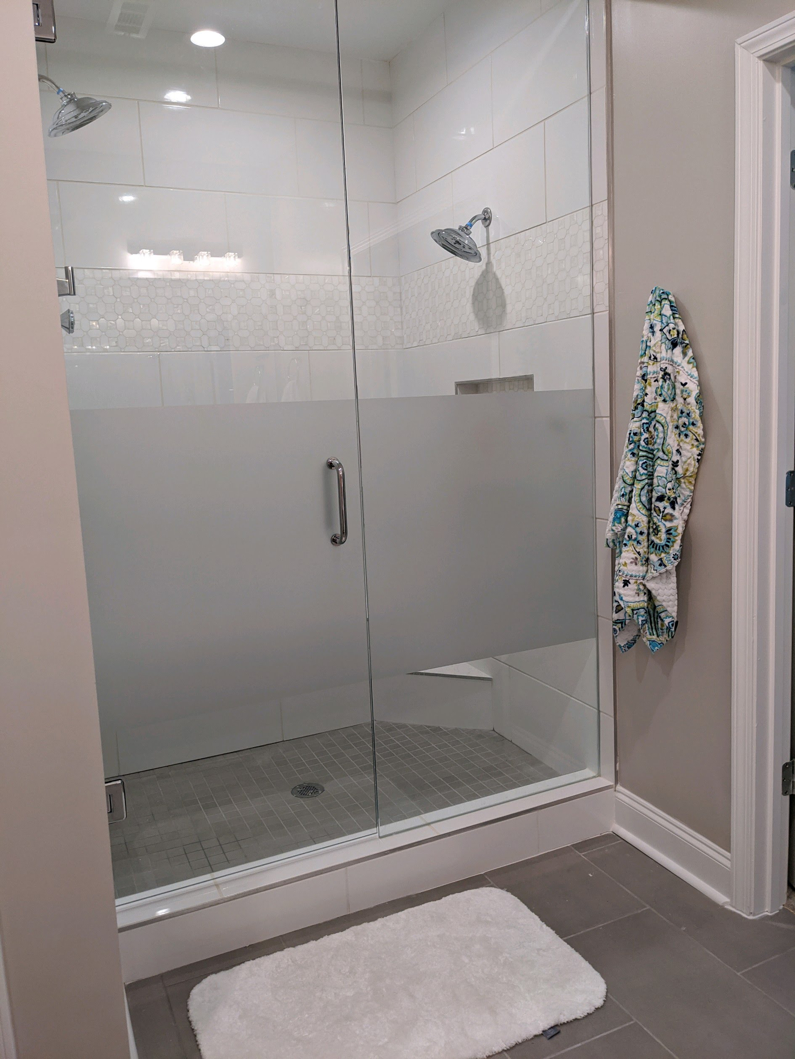 Privacy band on shower glass to provide privacy and maintain openness of the bathroom.
