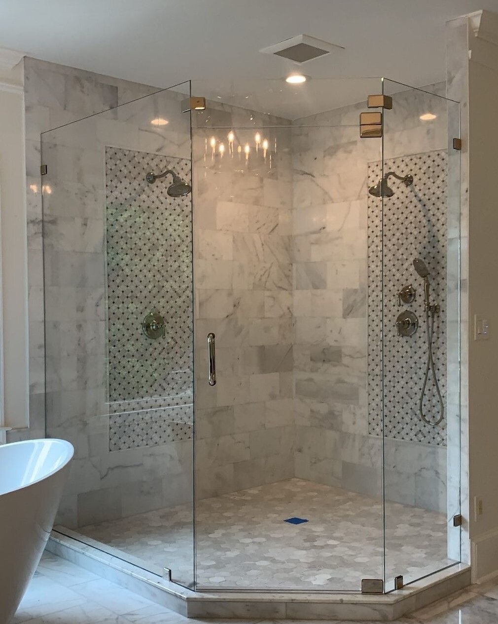 This low iron shower enclosure features a transom above the door to support its swing. Low iron glass is particularly stunning in light-colored bathrooms with a lot of natural lighting.