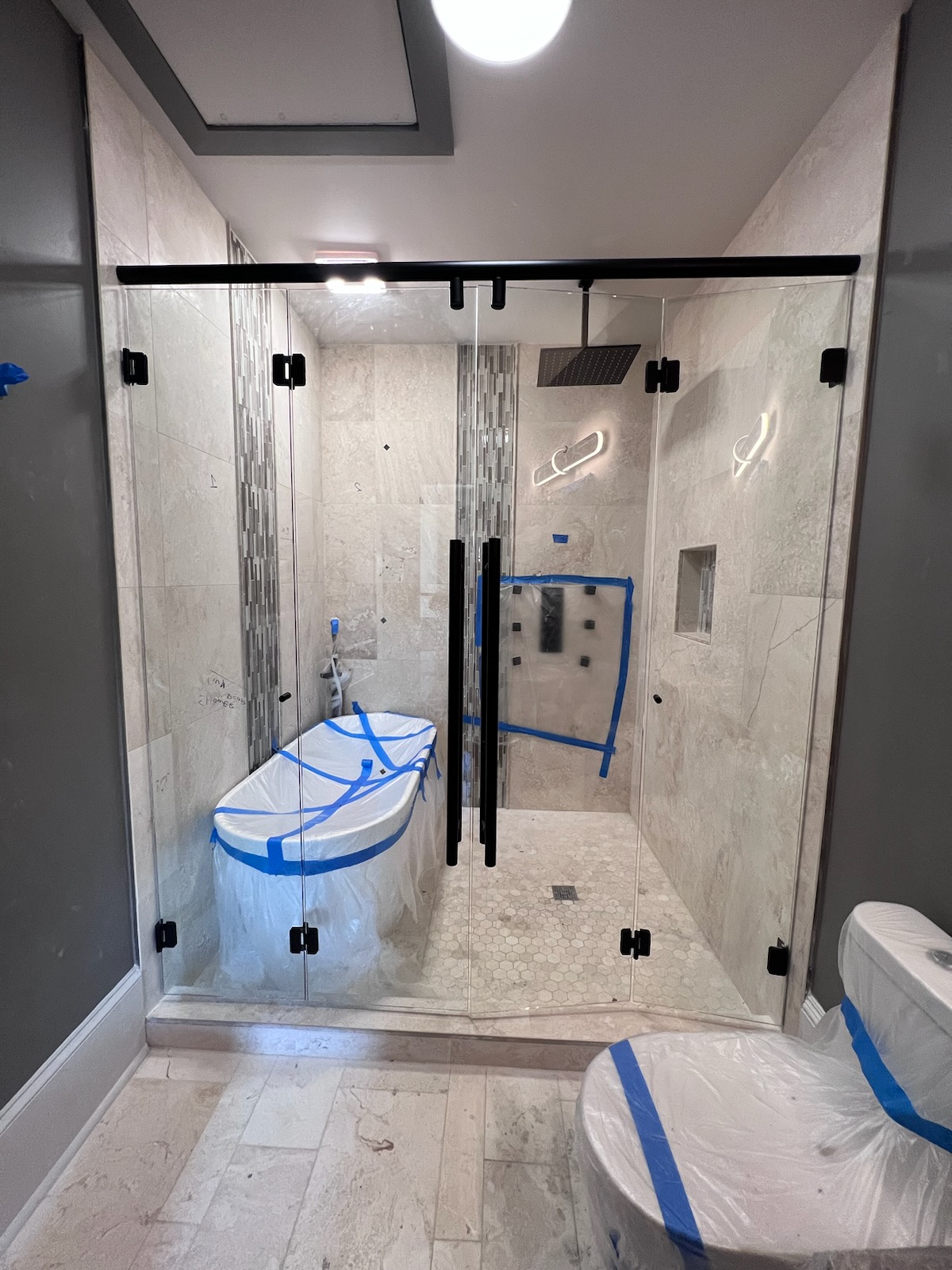 This Hydroslide / Pacifica double sliding bi-fold enclosure allows this homeowner to maximize their shower opening while preventing the doors from hitting the tub on the left or the toilet on the right. 
