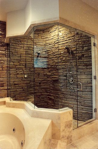 Stacked Stone Shower. Zig Zagged shaped glass panels are pressure fit into opening creating a dramatic shower design. Edges of glass panels were mitered for a perfect fit on the corners. Three hinges were used here but are not usually necessary in most situations.