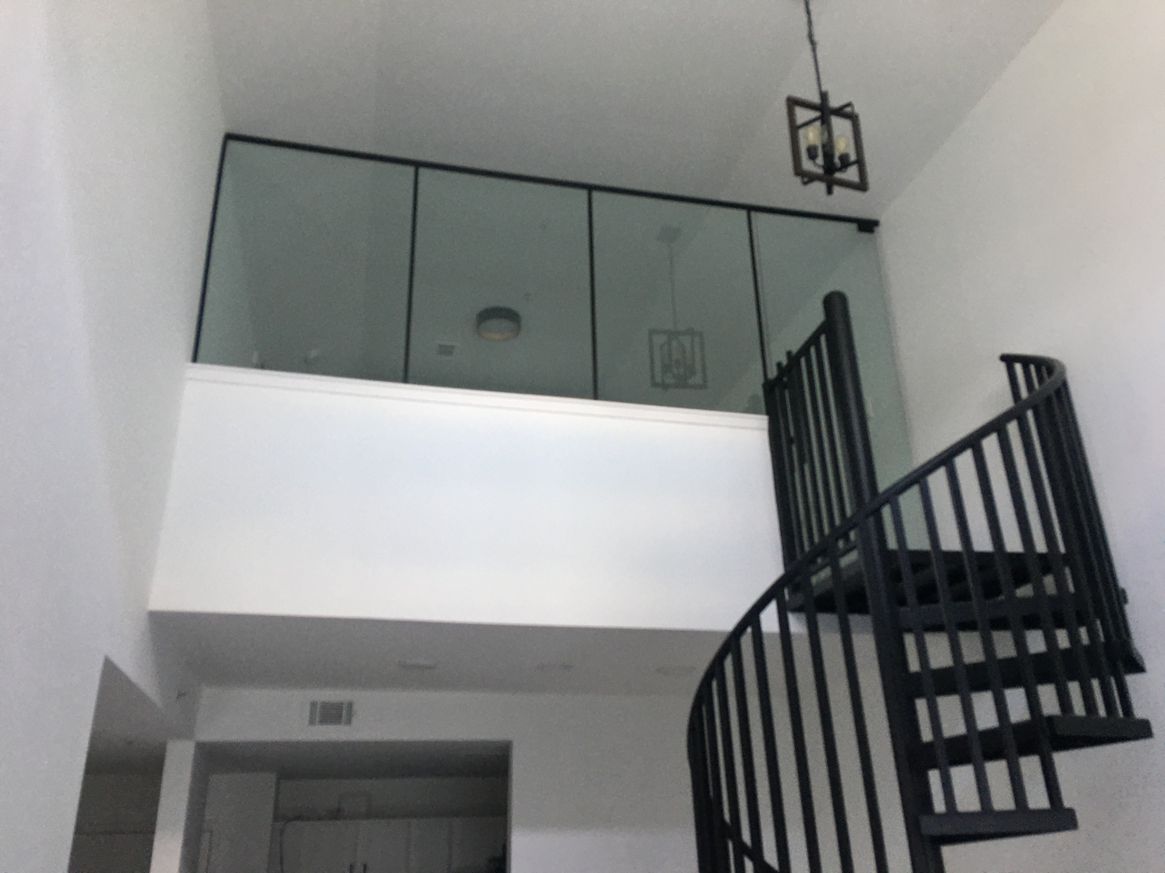 This loft partition in Atlanta involved carrying glass up a scaffolding/ladder because it was too large to fit up the spiral staircase! 