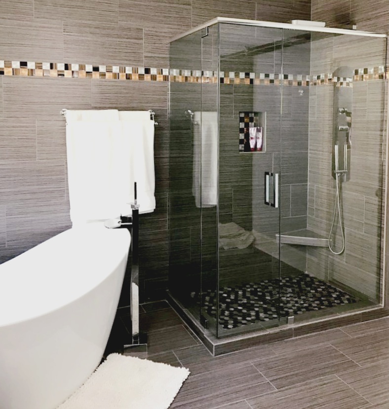 This shower features a specialty door on a corner! The whole corner opens up in a single piece.