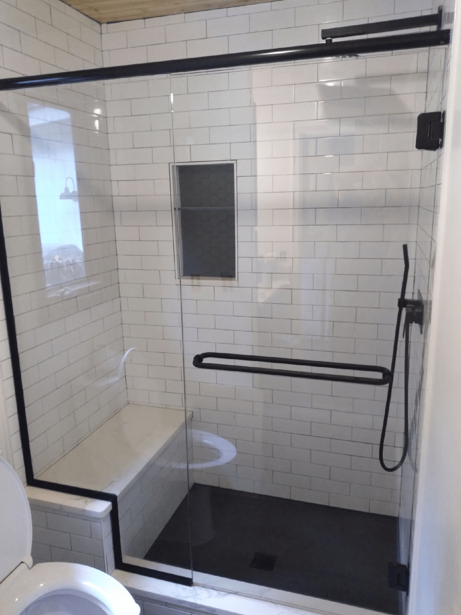 Inspired by a Pinterest post, we designed this shower enclosure to be frameless with matte black channeling for a more modern style.