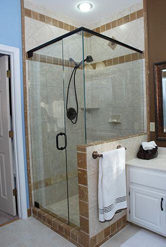 Oil-Rubbed Bronze Knee-Wall. This is a great example of updating the bathroom and shower by removing the old enclosure and replacing with a new frameless shower enclosure. Chrome and brushed nickel finishes look great with white tiles. Make sure your old shower structure is worthy of the investment of a new enclosure.